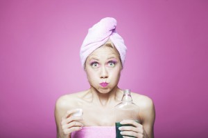 Young woman just taking care of her hygiene with mouthwash. More files of this model and series on port.