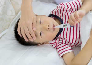 Checking fever on a little boy.